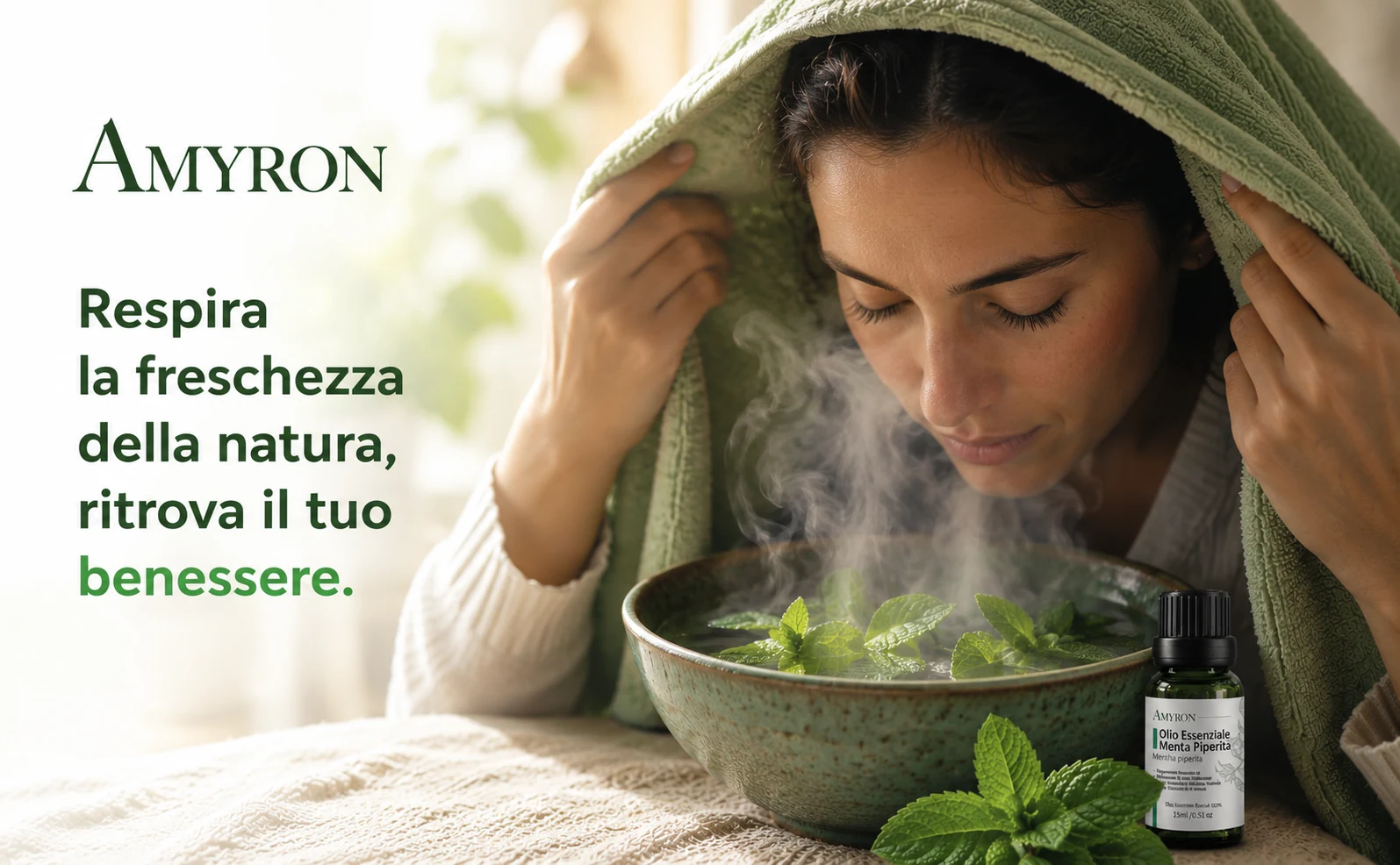 Olio essenziale di Menta Piperita AMYRON accanto a una ciotola fumante con foglie di menta